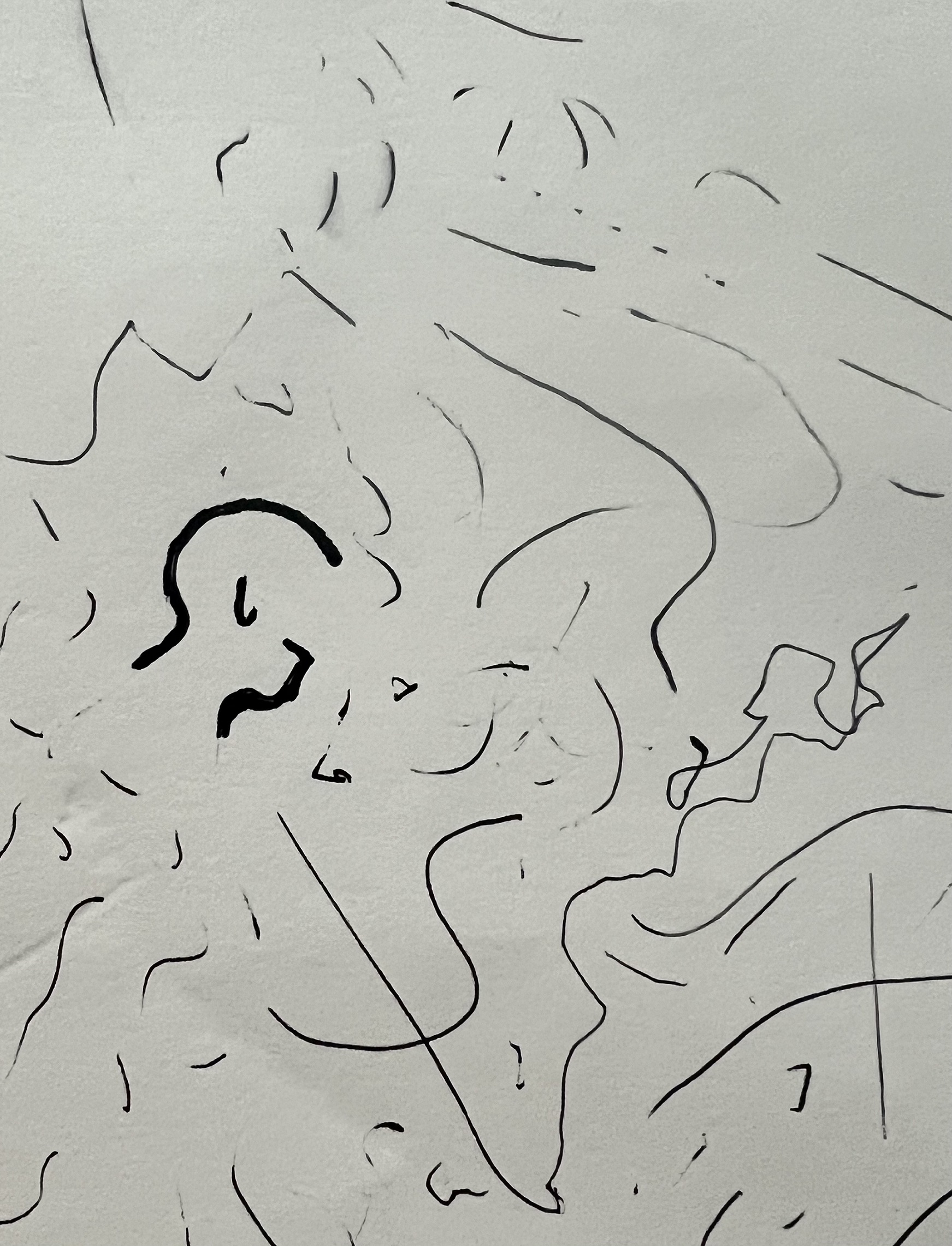 A series of squiggles and disconnected lines in black ink on a gray background