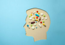 Researchers: “We Do Not Suggest” Antipsychotics for Depression A cutout of a head as if made of blue paper. The head is full of pills.