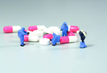 Protecting the False Narrative About Antidepressants Miniature scientist at work with Medicine pills