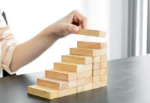Why Psychotherapy Should Busy Itself with Building Character Strengths, Not Reducing Symptoms Stacking wooden blocks upward like stairs