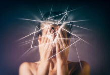 Patients Tell of ECT Harms A person covers their face while white jagged lines emerge from their head