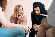 Fully Recovered after Psychosis, Without Antipsychotic Drugs Group of teenagers sitting together and smiling during a support meeting