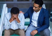 Sober Living: Why Less Clinical Sometimes Means More Recovery Shot of a young man comforting his peer on the steps