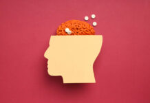 Antipsychotics—And How I’ve Learned to Manage the Side Effects Paper head with brain and pills on red background