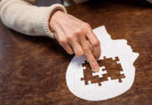 “I Can’t Remember a Single Day”: New Survey Shows Disastrous Memory Effects of ECT An elderly person's hand pushes a puzzle piece into a flat empty head shape