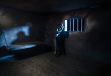 Fifty Years of Grief Miniature photography. Lonely man bathed in moonlight in a prison cell