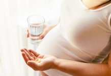 Micronutrient Supplements: Better Than Antidepressants for Depressed Pregnant Mothers and Their Babies Supplements vitamins pill. Happy young pregnant woman holding supplement vitamin pill. Therapy, healthcare, motherhood concept