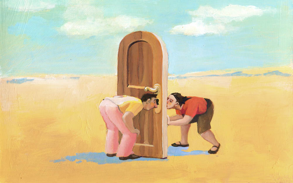 a man and a woman in the desert they look through a keyhole