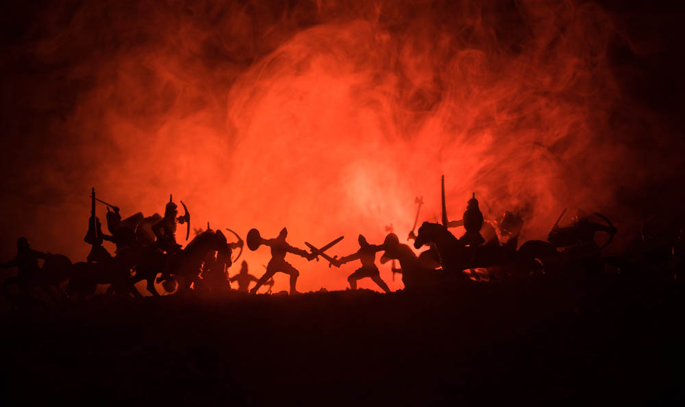 Ancient soldiers in silhouette against an orange fog