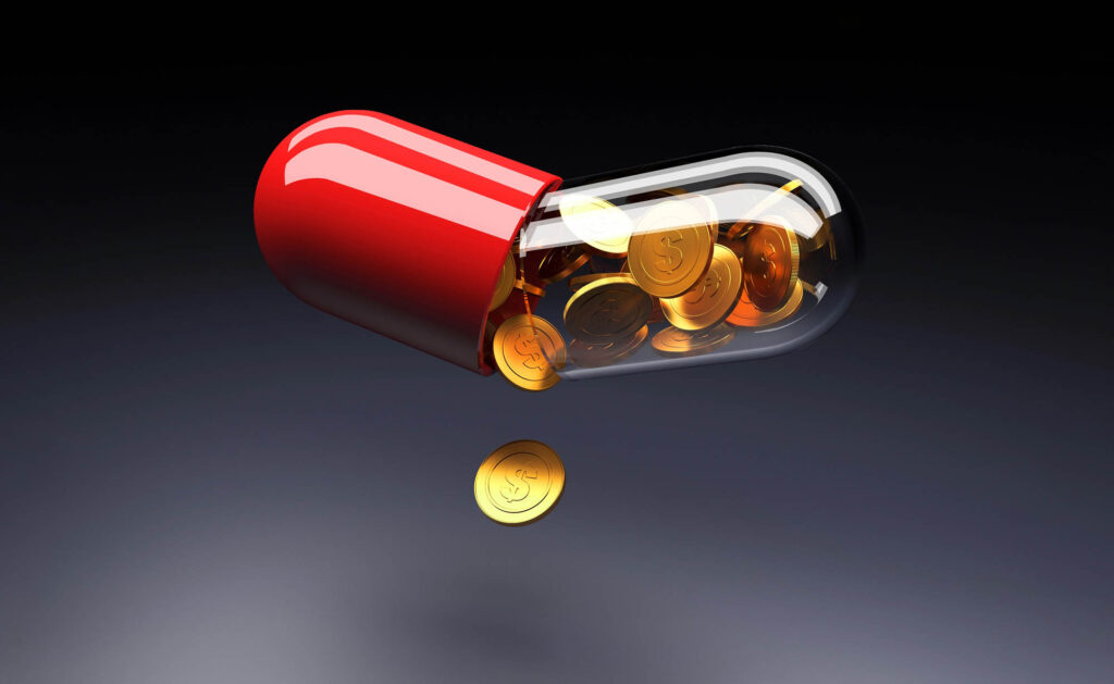 A pill capsule breaks open, coins spilling out