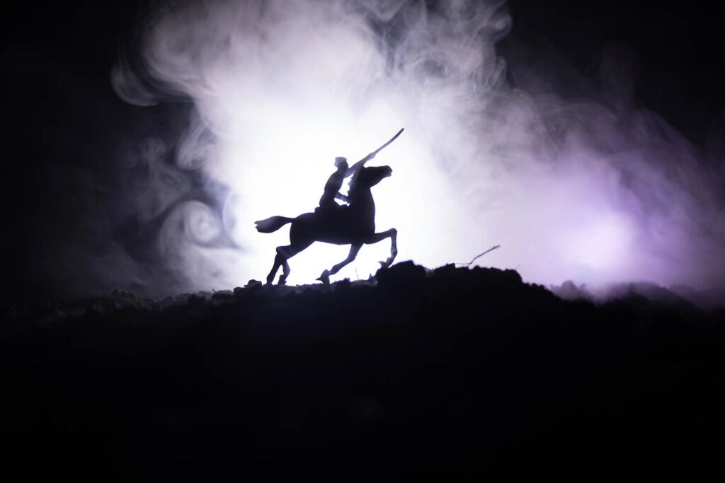 Miniature dramatic photo of a soldier with a sword on a horse